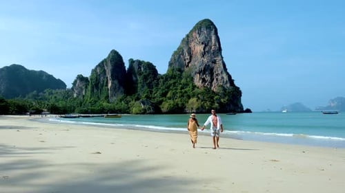 Serene Beach Stroll in Railay Krabi Thailand with Stunning Mountain Backdrops