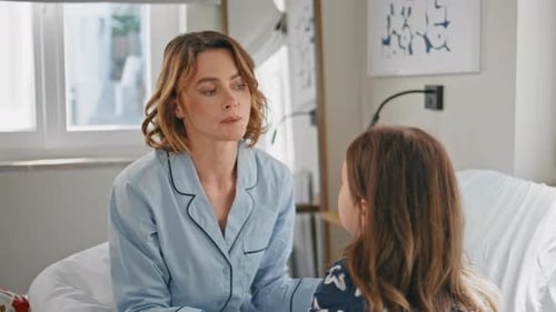 Mother and Daughter Talking on a Bed
