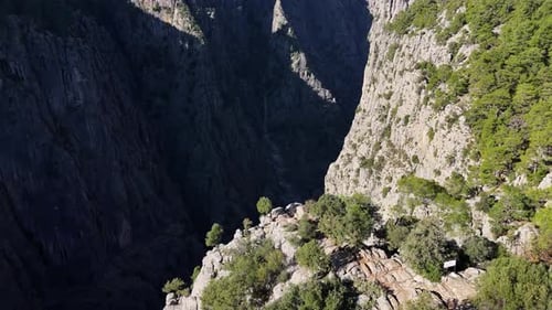 Aerial View of a Canyon with Deep Cliffs and Rocky Formations