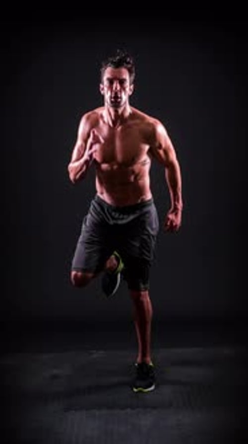 Muscular Man Performing High Knee Exercise