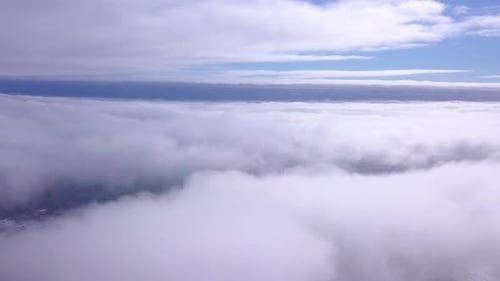 Aerial View of Puffy Clouds Above Ocean