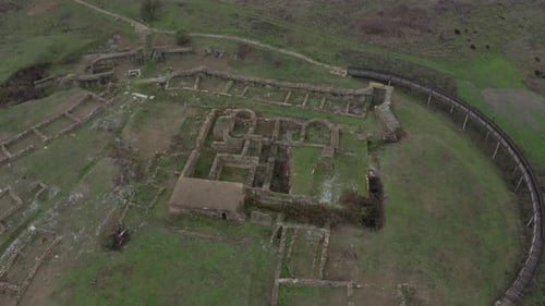Aerial view of ancient city ruins in Bulgaria in an empty green field