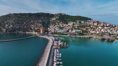 Aerial Video of a Modern City Skyline With Skyscrapers and an Azure Sea in the Background Captured