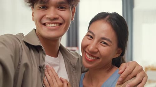 Smiling Couple Video Chatting Indoors