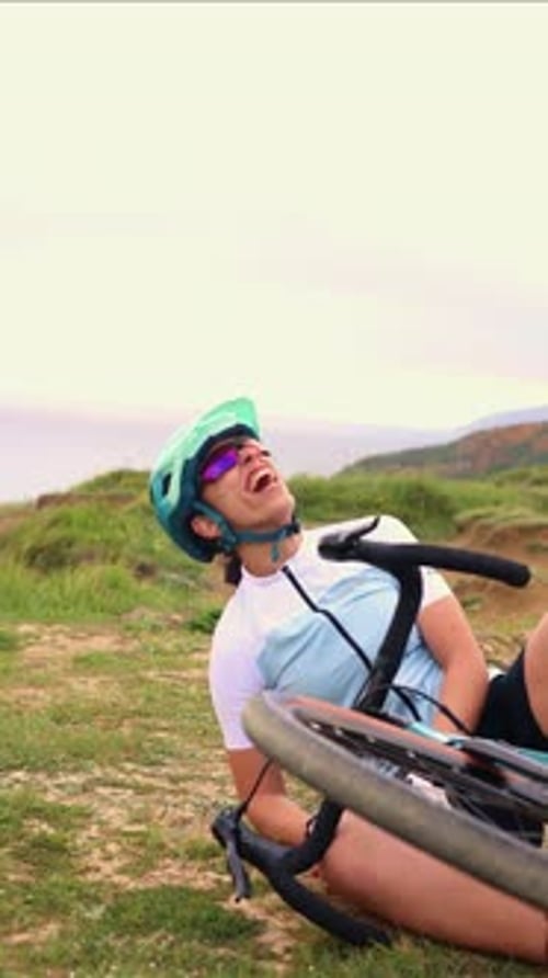vertical Latin cyclist woman falling off her gravel bike