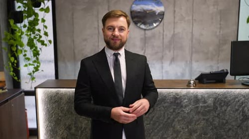 Professional Hotel Concierge Welcoming Guests at Reception Desk