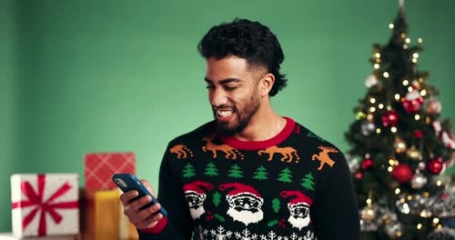 Happy, man and online shopping with smartphone, Christmas and browsing for gift discount and studio