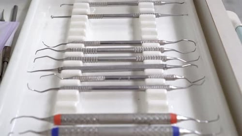 Close-up of sterilised dentist's instruments for working on teeth arranged on medical cabinet. Denta