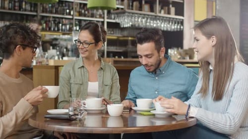 Group of Positive Mixed race Young People Having Conversation in Coffee Shop.