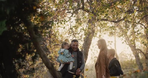Family with Two Children Have Fun in Autumn Park