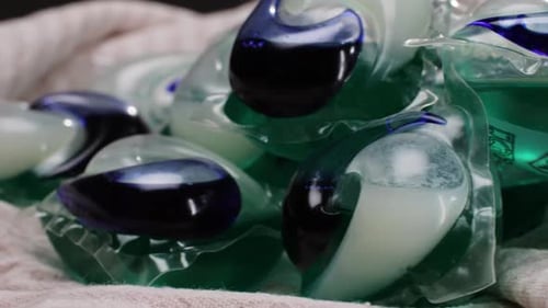 Laundry Detergent Pods Macro Close-Up on Cloth