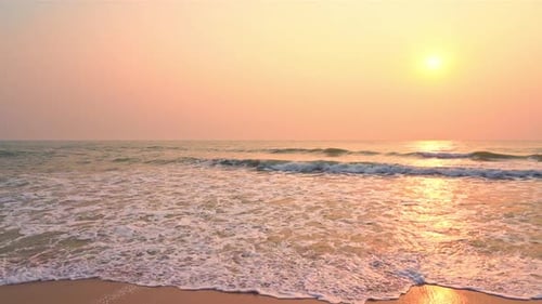 Small ocean sea waves on a sandy beach during sunset. Background landscape picture of dusk or dawn a