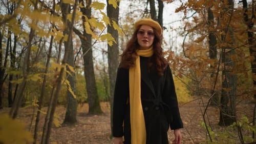 Stylish Lady in Autumn Attire Walking Forest Path