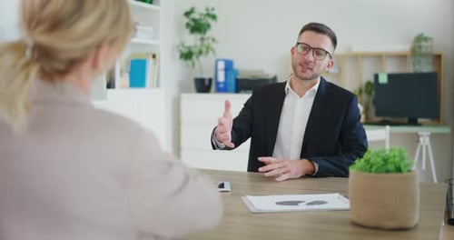 Real Estate Agent Finalizes Sale Shakes Hands with Client