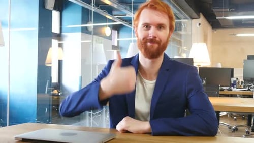 Thumbs Up By Man in Office Red Hairs