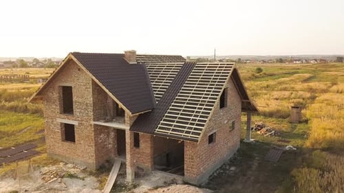 Aerial View of Unfinished House with Wooden Roof Structure Covered with Metal Tile Sheets Under