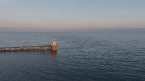 Aerial Golden Hour Views of Blyth Lighthouse With the Full Moon Rising