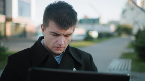 Focused Data Analyst Outdoors with Urban Background