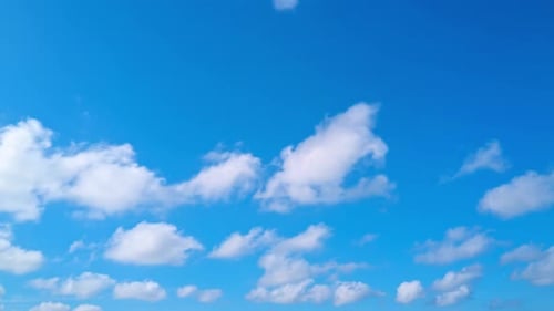 Billowing Clouds Moving Across a Clear Blue Sky