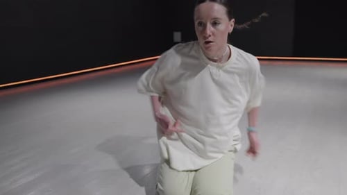 Graceful Female Dancer Expresses Herself in a Dark Studio with Orange Accent Lighting