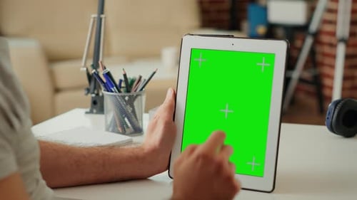 Office Worker Vertically Holding Digital Device with Isolated Greenscreen