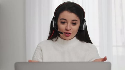 Woman with Headset Talking at Computer