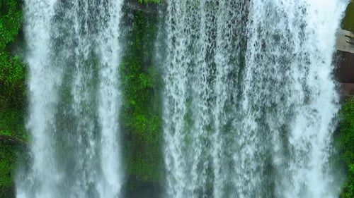 A waterfall in a beautiful tropical forest. Drone view.
