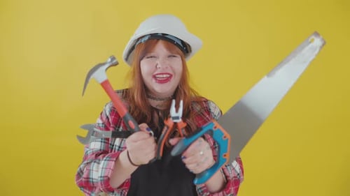 Female Construction Worker Holding Tools