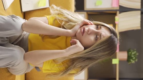 Vertical video of Unhappy female student is studying.