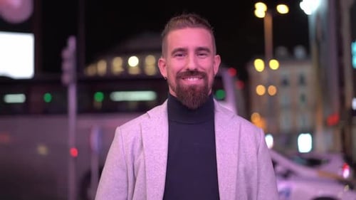 Bearded Man Smiling at Night in City