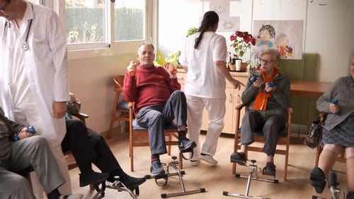 Caregivers Assisting Senior People in Pedal Exercise and Weightlifting at Rehabilitation Center