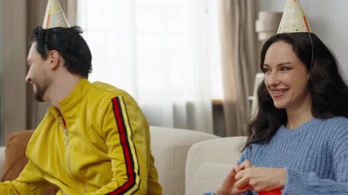 Couple Celebrating a Birthday at Home with Balloons