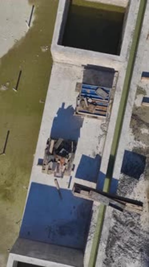 Vertical Video of an Exposed Metal Structure of a House Under Construction Captured From Above in a