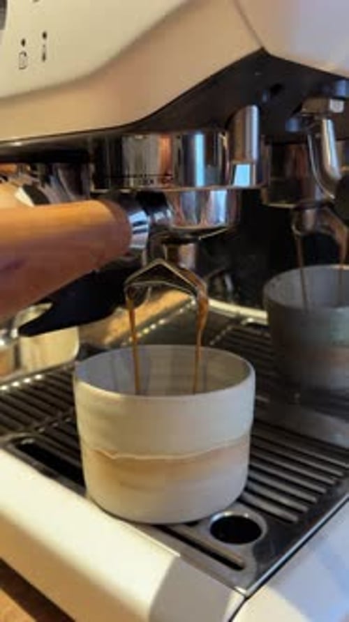 Espresso Extraction Close-up from Professional Coffee into Ceramic Cup Slow Motion Detail