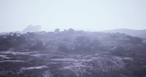 Misty Landscape with Rocky Terrain Under Soft Natural Light in Remote Area