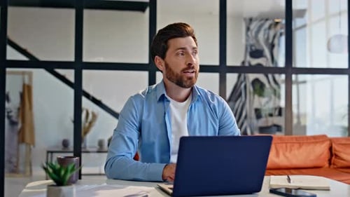 Man Working From Home Using Laptop on Video Call