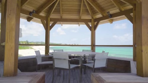 gazebo with white round table and chair on a tropical beach for meeting gathering and conference