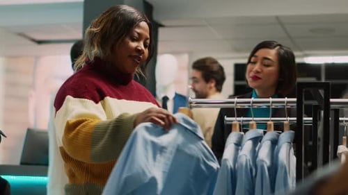 Woman Browsing Clothes with Sales Associate in Retail Store