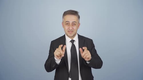 Enthusiastic Man in Suit Gesturing to Camera