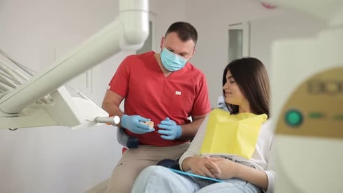 Dentist Explains Procedure to Patient in Modern Office