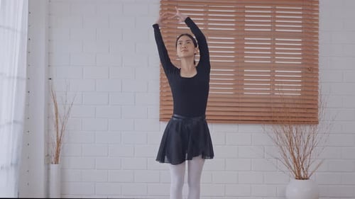 Young Woman Stretching in Ballet Clothes