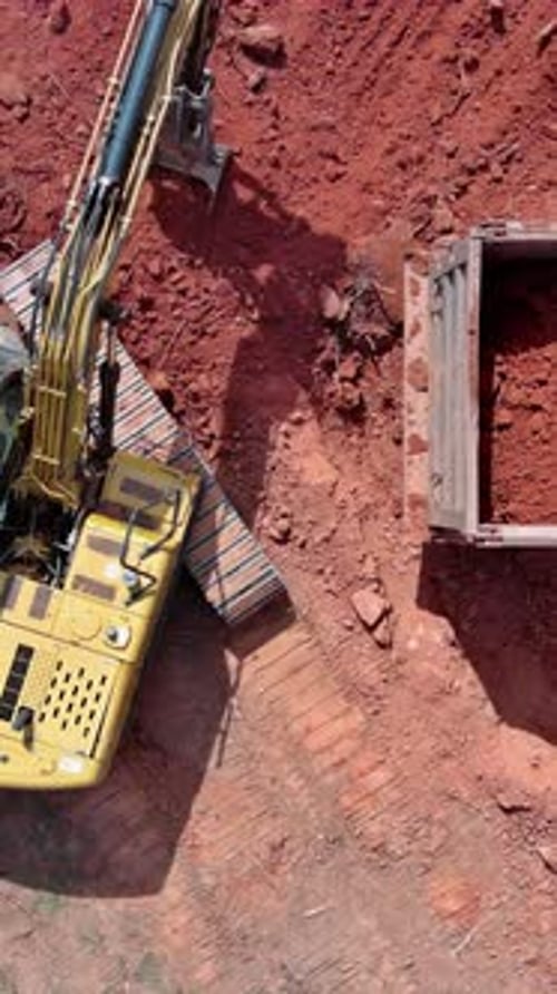 Construction Site Excavator Loads Earth Into Dump Truck Preparing Area for Built Home