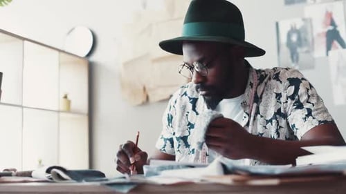 Male Designer Working on Fashion at Desk
