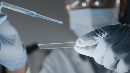 Dropping Liquid onto Slide for Medical Research