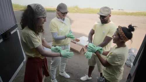 Volunteers Stack Hands Ready to Clean Beach