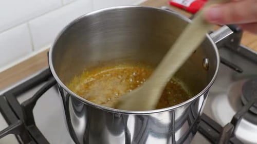 Cooking Video. Close up of food preparation placing ingredients in to a pan ready for cooking and sh