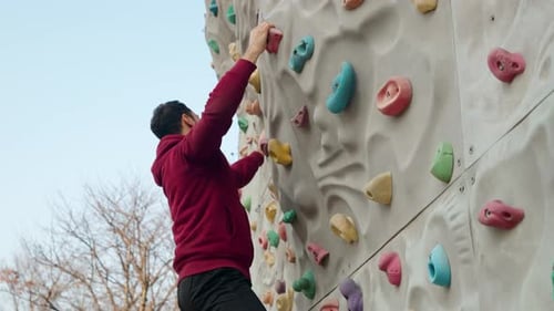 Young Adult Climbing Outdoor Rock Wall