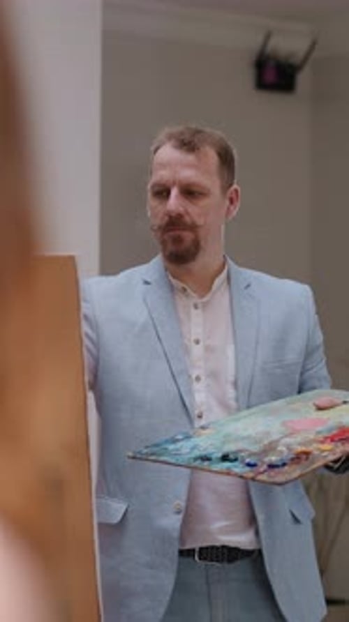 Artist with Piercing Eyes Draws Life in Studio