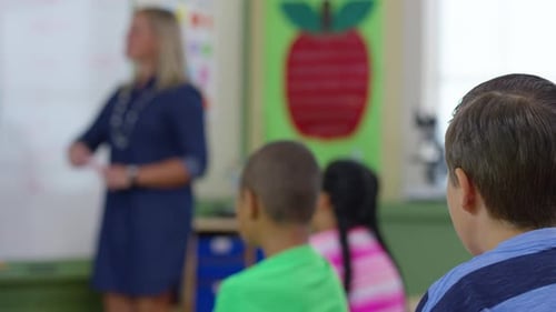 Enthusiastic students raise hands eagerly during engaging lesson in school classroom
