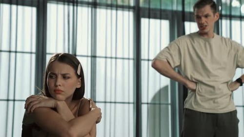 Upset Woman with Arms Crossed and Angry Man Talking